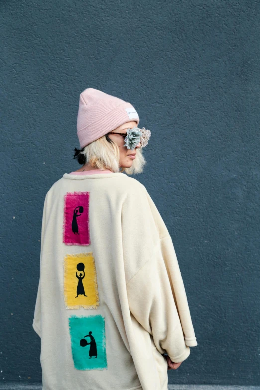 a woman with a hat and sunglasses looking back