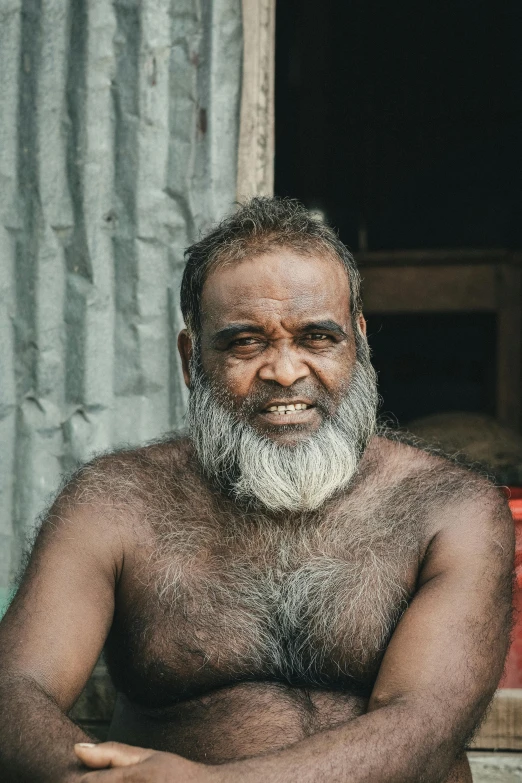 a man with a long gray beard and large black hair