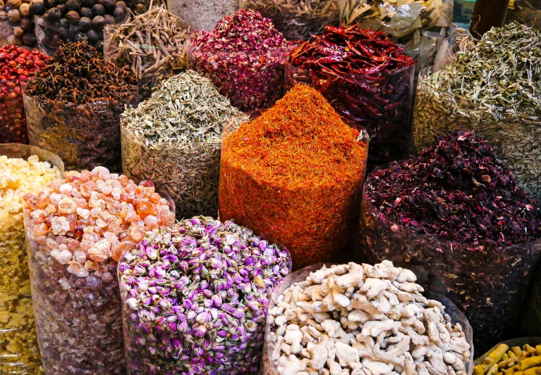 many different colored flowers in bags on display