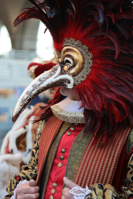 a man is dressed in costume with the colorful mask