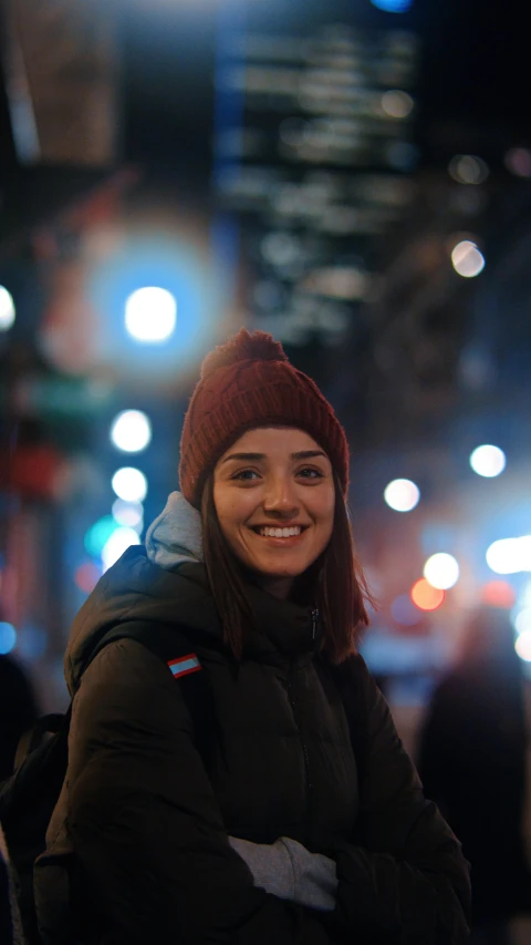 a girl wearing a winter hat is posing