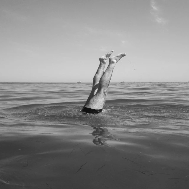 a woman is in the ocean jumping up into the water