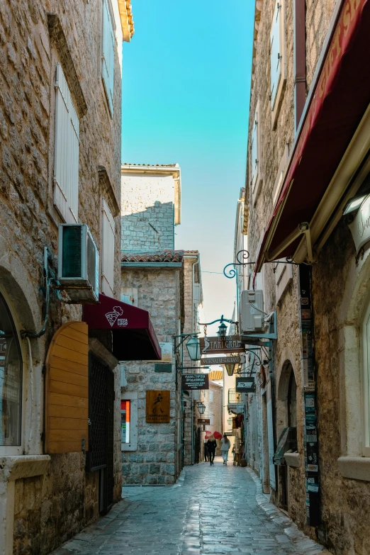 an empty narrow alley with a small window