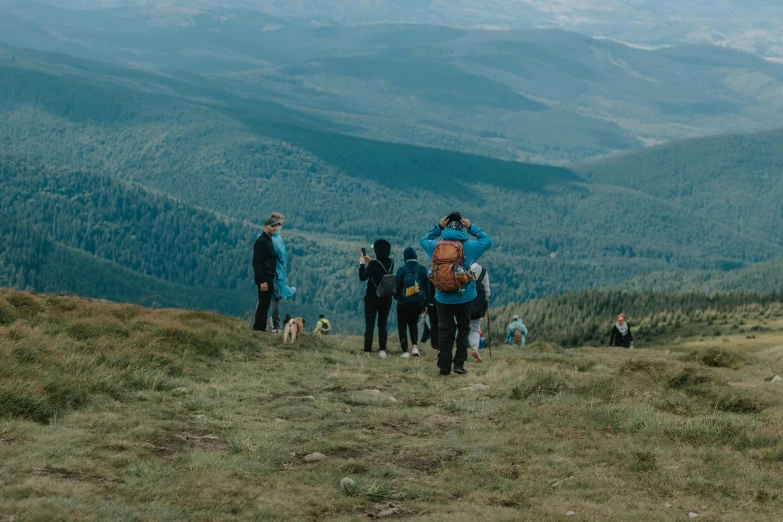 group of hikers looking down at mountains and a valley