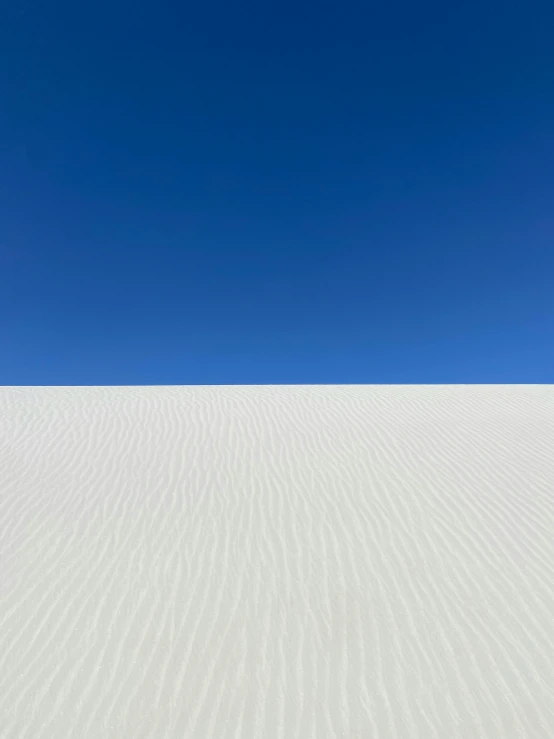 a lone man on top of a dune