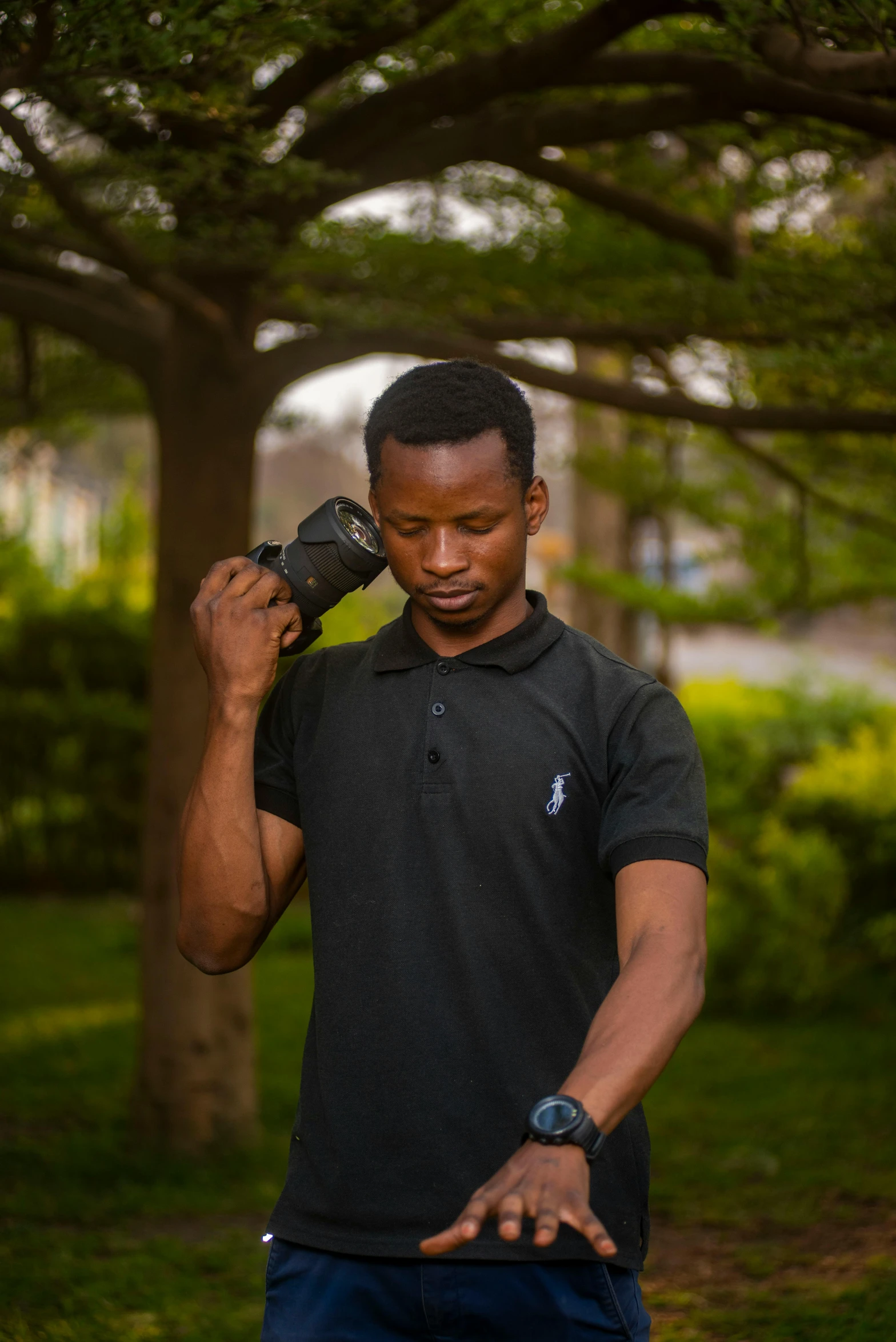 man holding a cellphone to his ear in park