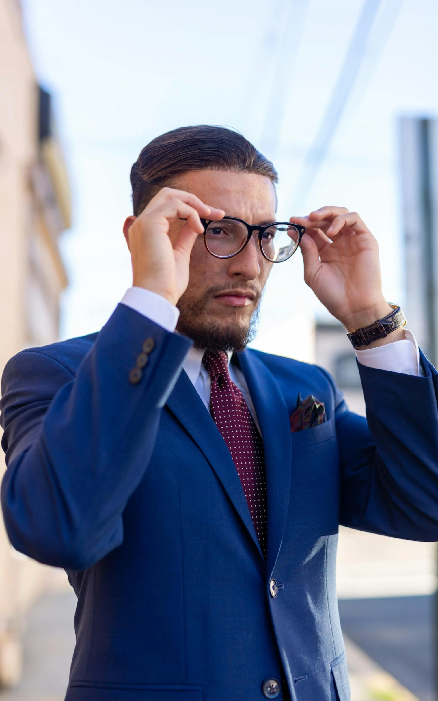 man with glasses looking over his head