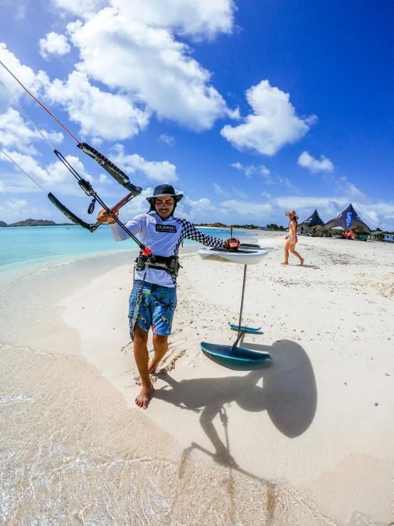 a person holding up some fishing rods on the beach