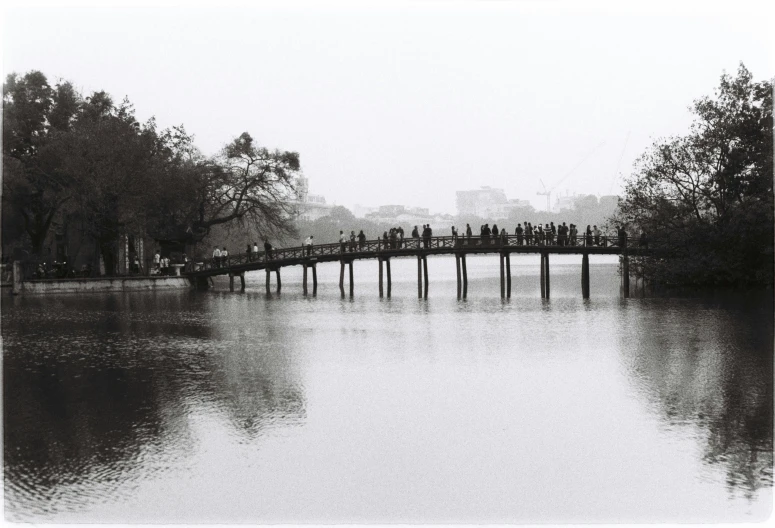 this is people on a long bridge over water