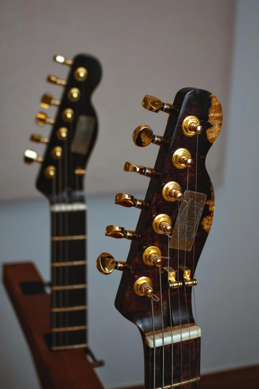 a guitar is sitting on a table with gold caps