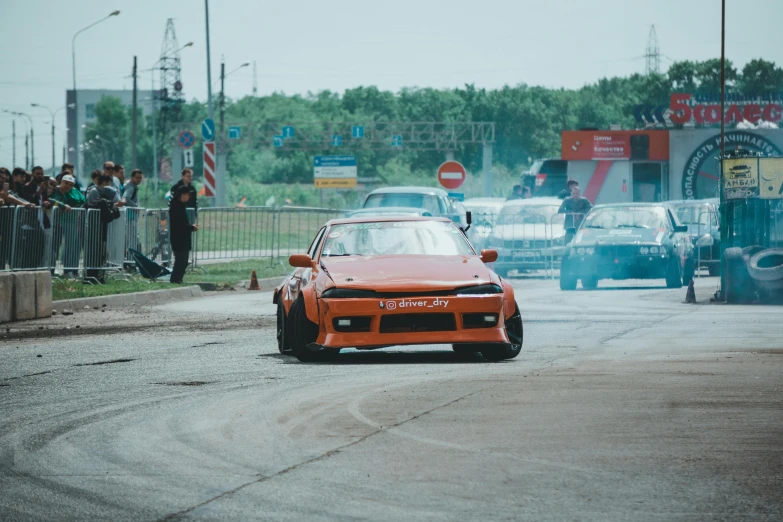 a car that is on the street with a lot of people watching