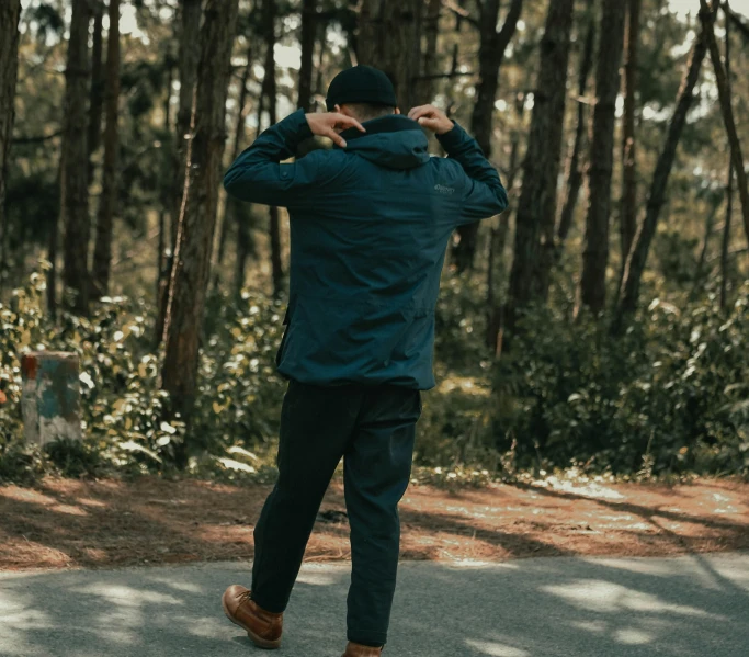 the man is dressed in a blue coat and a brown hat