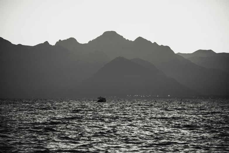 a small boat in the middle of the ocean