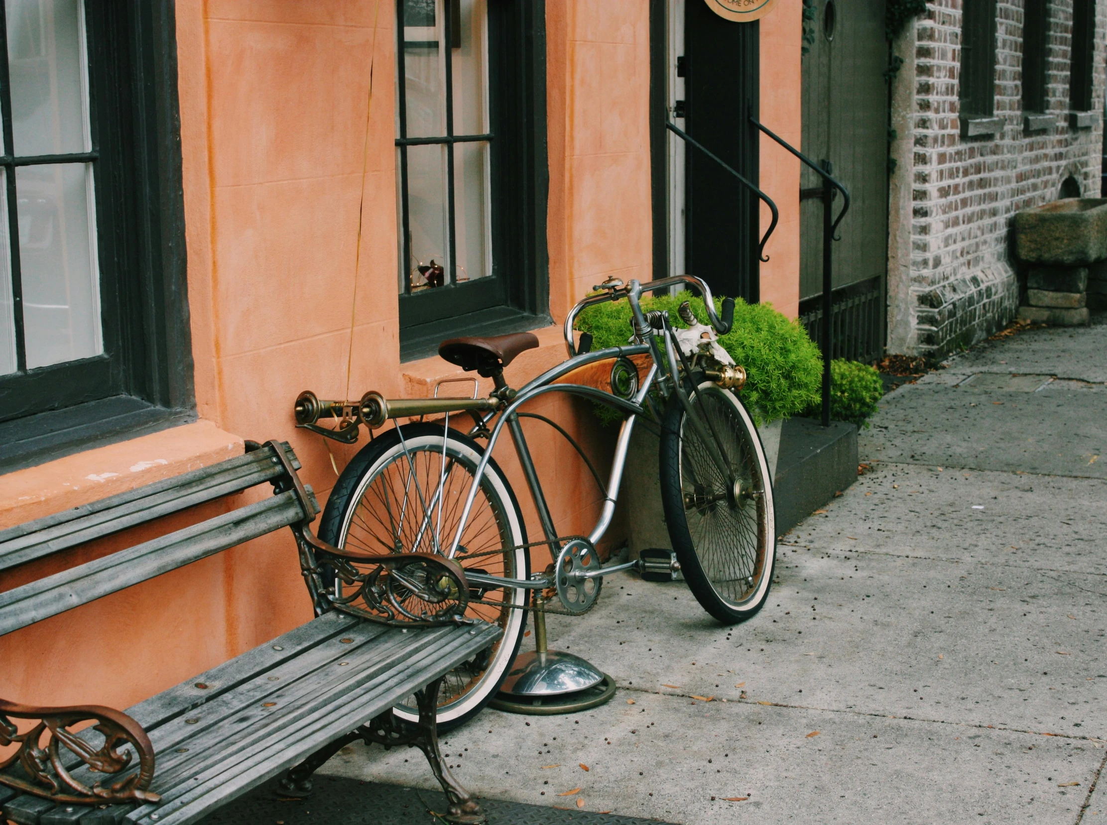 the bike has its bike rack and is next to the bench