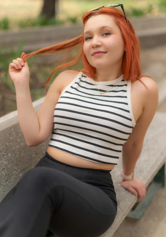 a woman in a striped shirt is posing