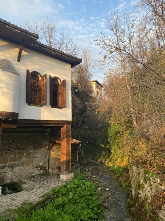 an old run down house with a stone pathway