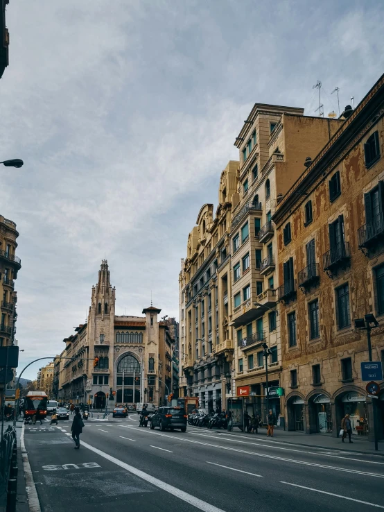 a city street lined with traffic and buildings