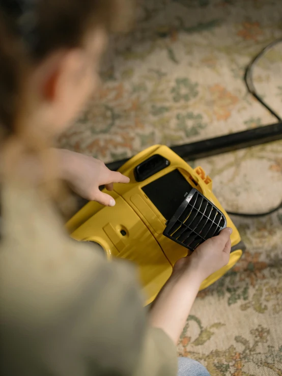 a woman is playing with a small yellow toy