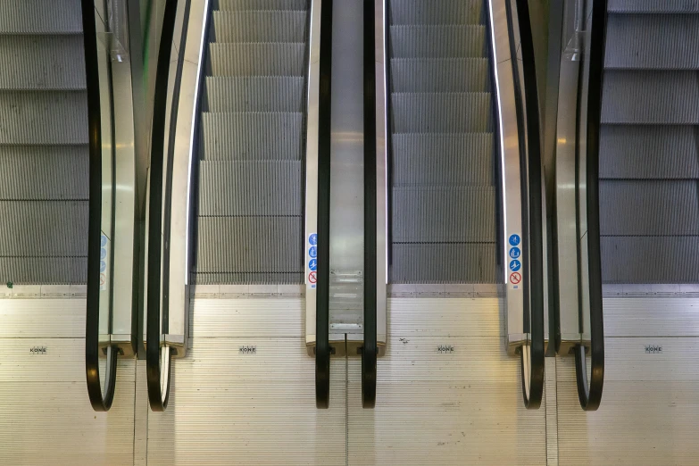 a row of metal steps leading to a subway stop