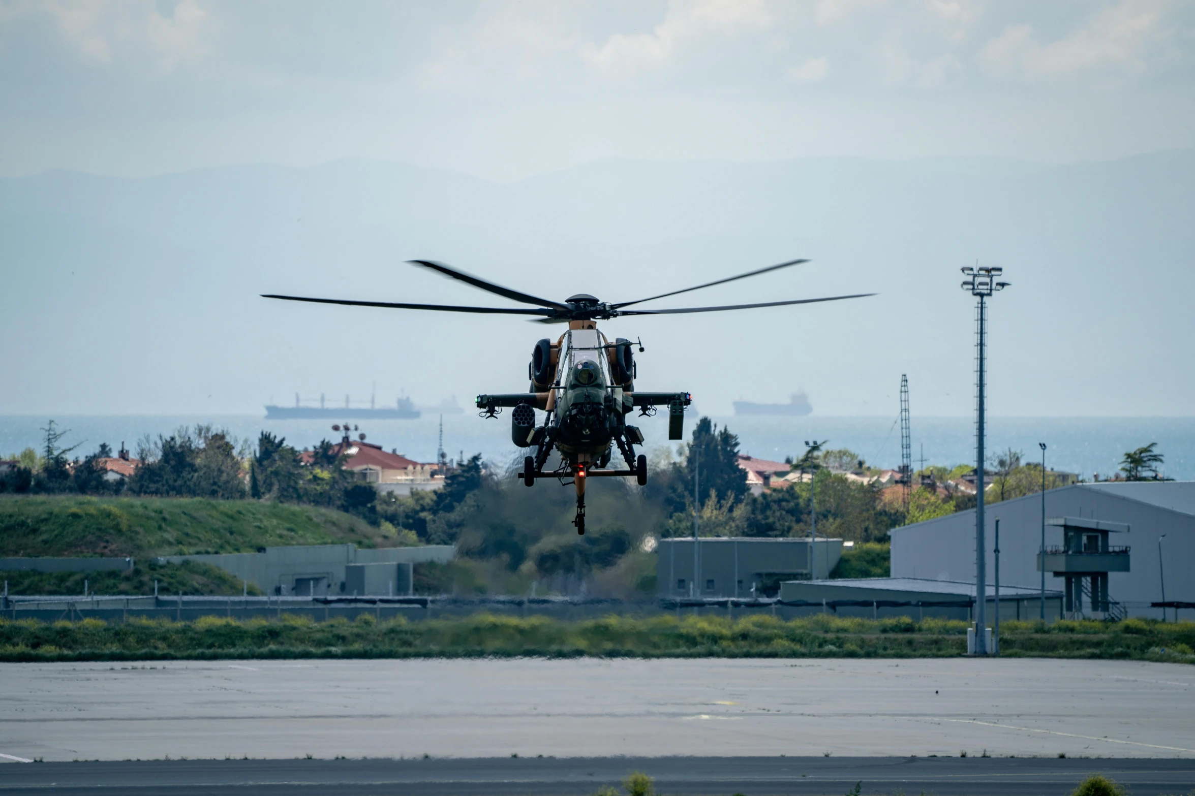 a helicopter is making a landing on an airport runway