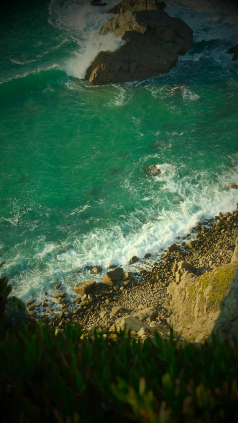 a po of a beach with some green water