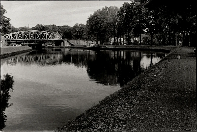 the train bridge is crossing over the water