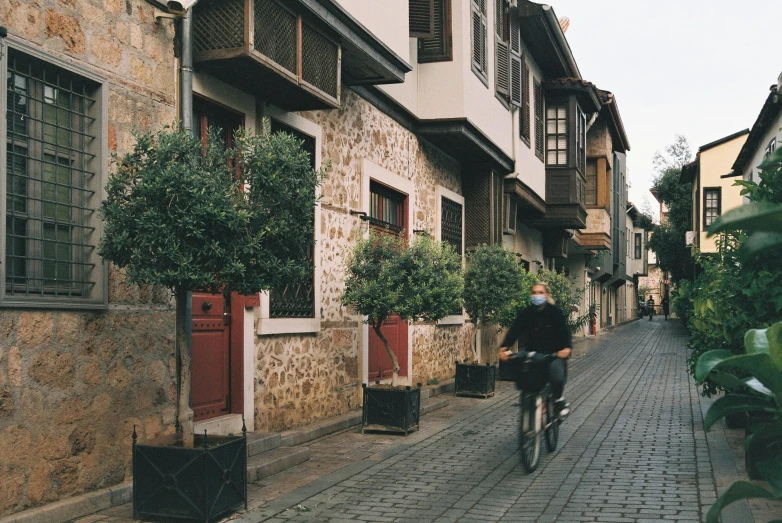 a person is riding a bicycle down a narrow alley way