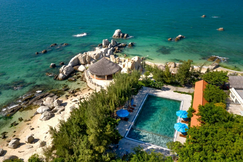 an aerial view of a resort on the water with a beach