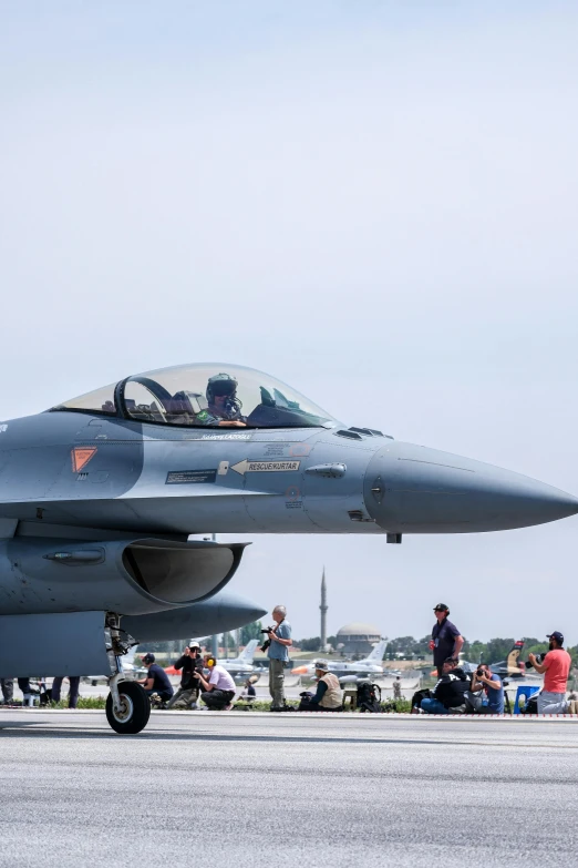 a fighter jet is parked on a tarmac