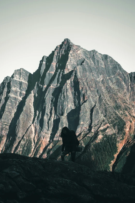 a hiker standing on top of a mountain ridge