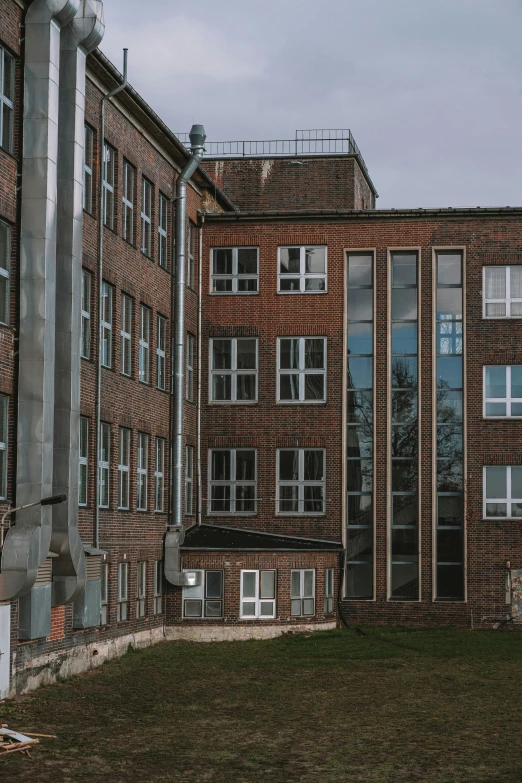 a street sign in front of a large brick building