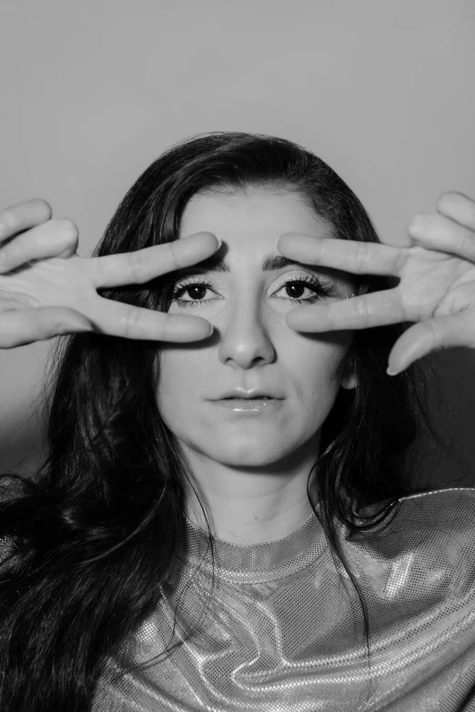 a young woman holding her fingers to the camera