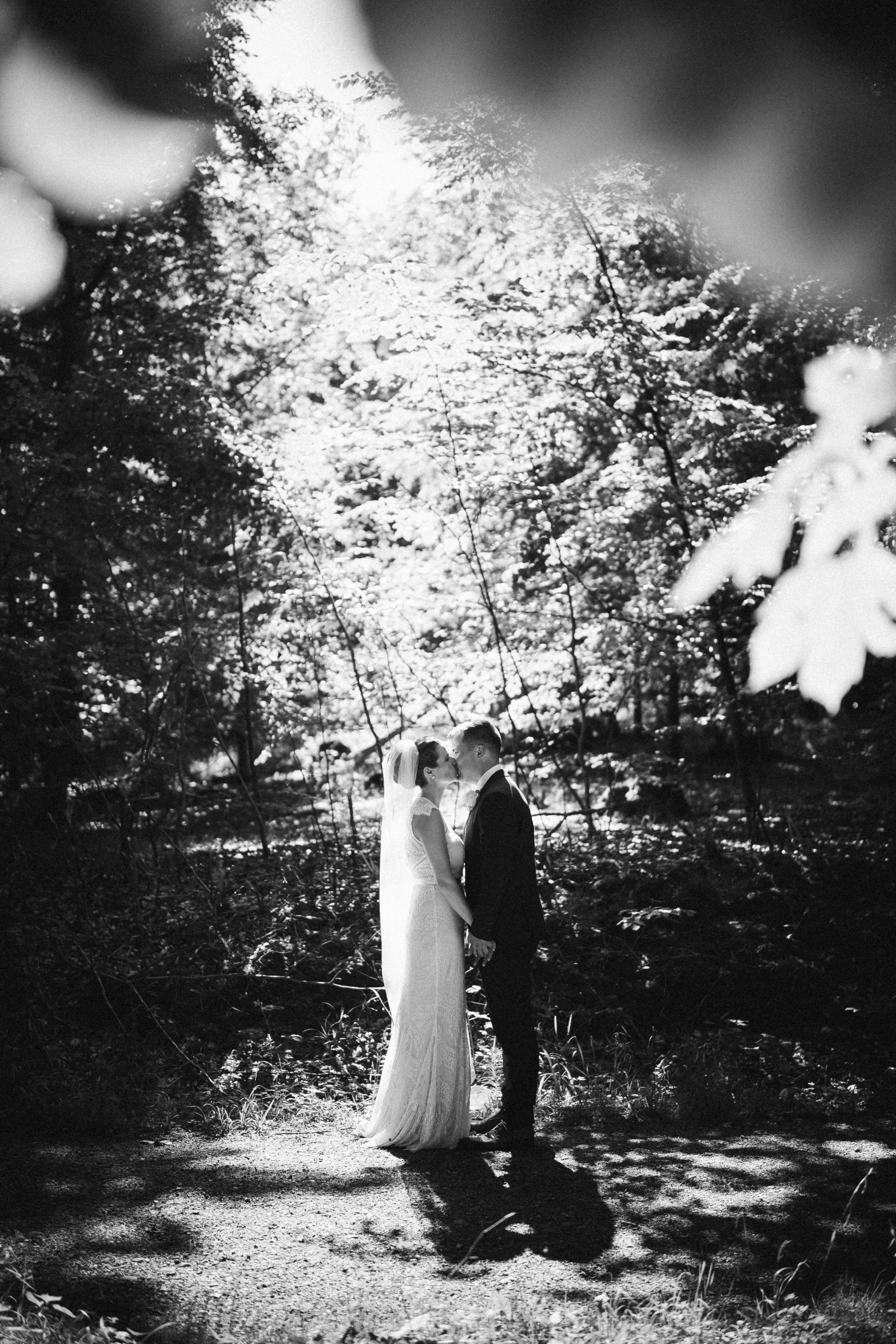 a black and white po of two people in the woods