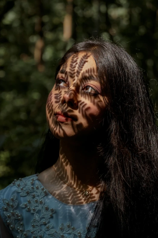 woman with painted body art in the forest