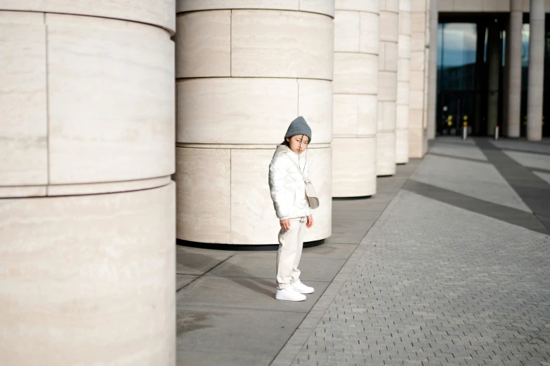 a person standing next to a wall of cement