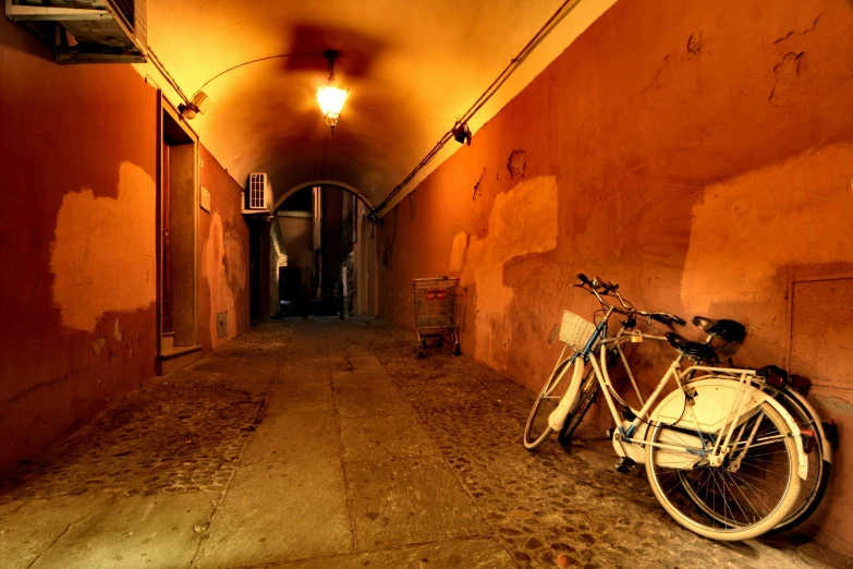 a bicycle leaned up against a wall next to a light