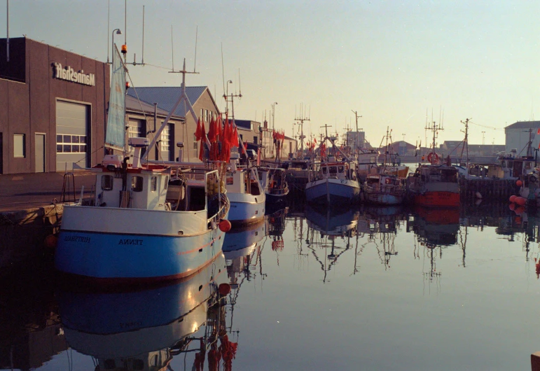 boats are in the water by some buildings