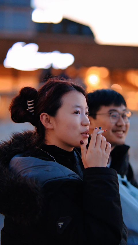 several women stand side by side outside at night