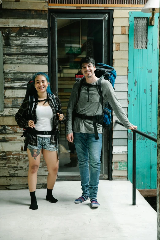 a man standing next to a woman while holding onto a rope