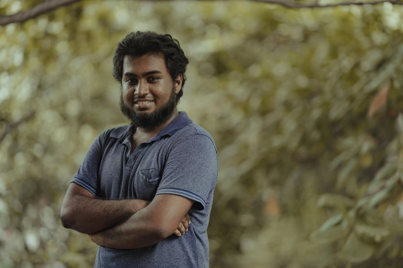 a guy with a beard smiles at the camera