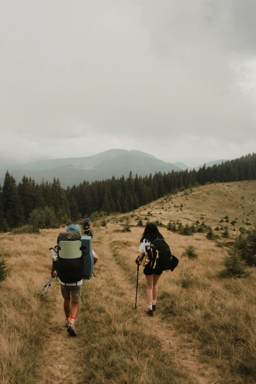 two people are walking on the hiking trail