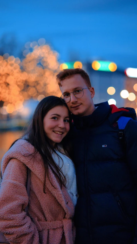 a couple smiling for a pograph while standing next to each other