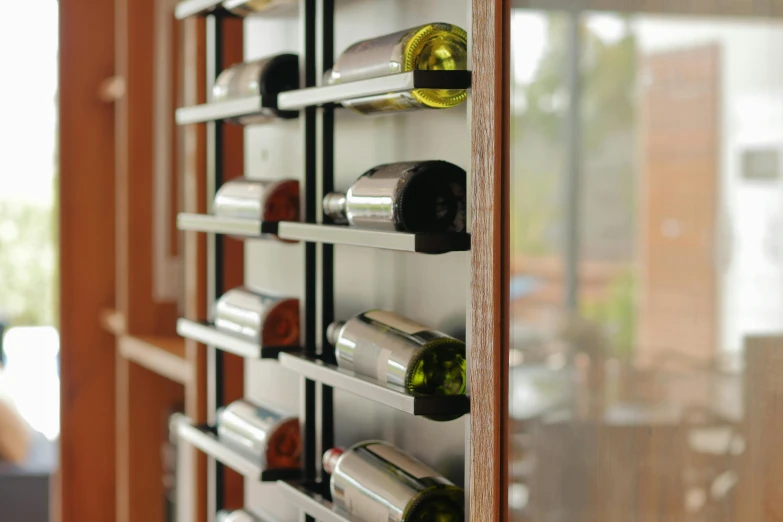 a wooden display rack holding several different types of wine bottles