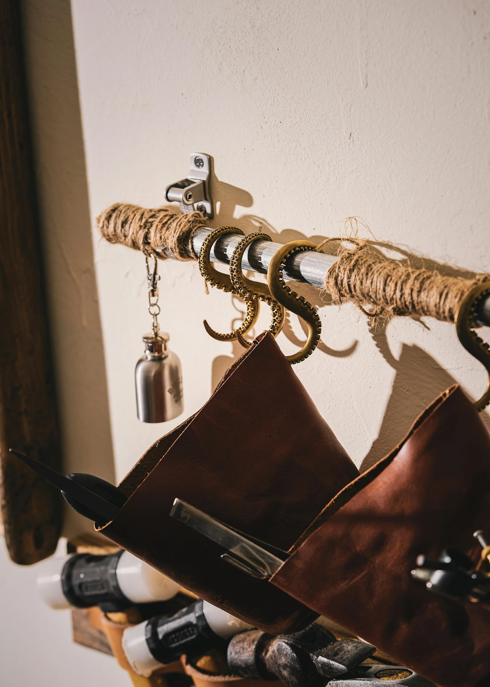 several bottles and a wallet hanging on a wall