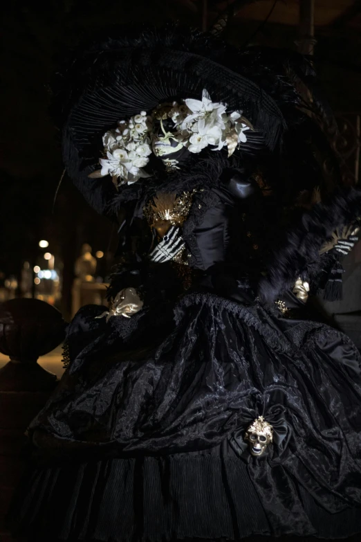 an elaborate dress is on display on a table