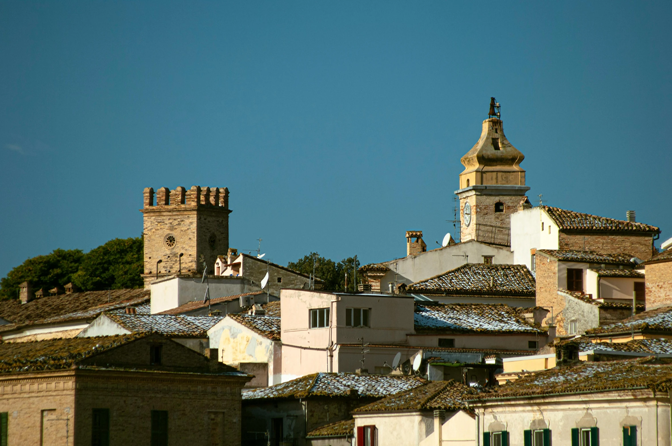 a city with very tall buildings next to small towers