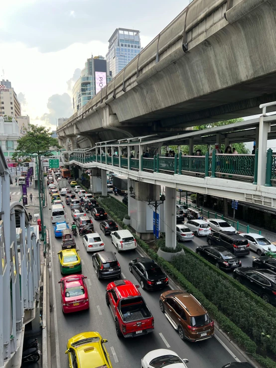 cars moving along an elevated road with a high overhead view of city buildings