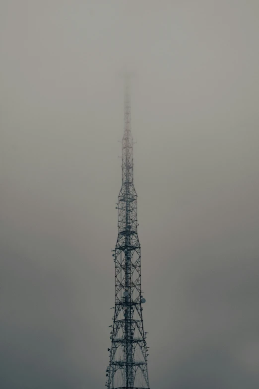 an antenna tower on top of a snowy mountain