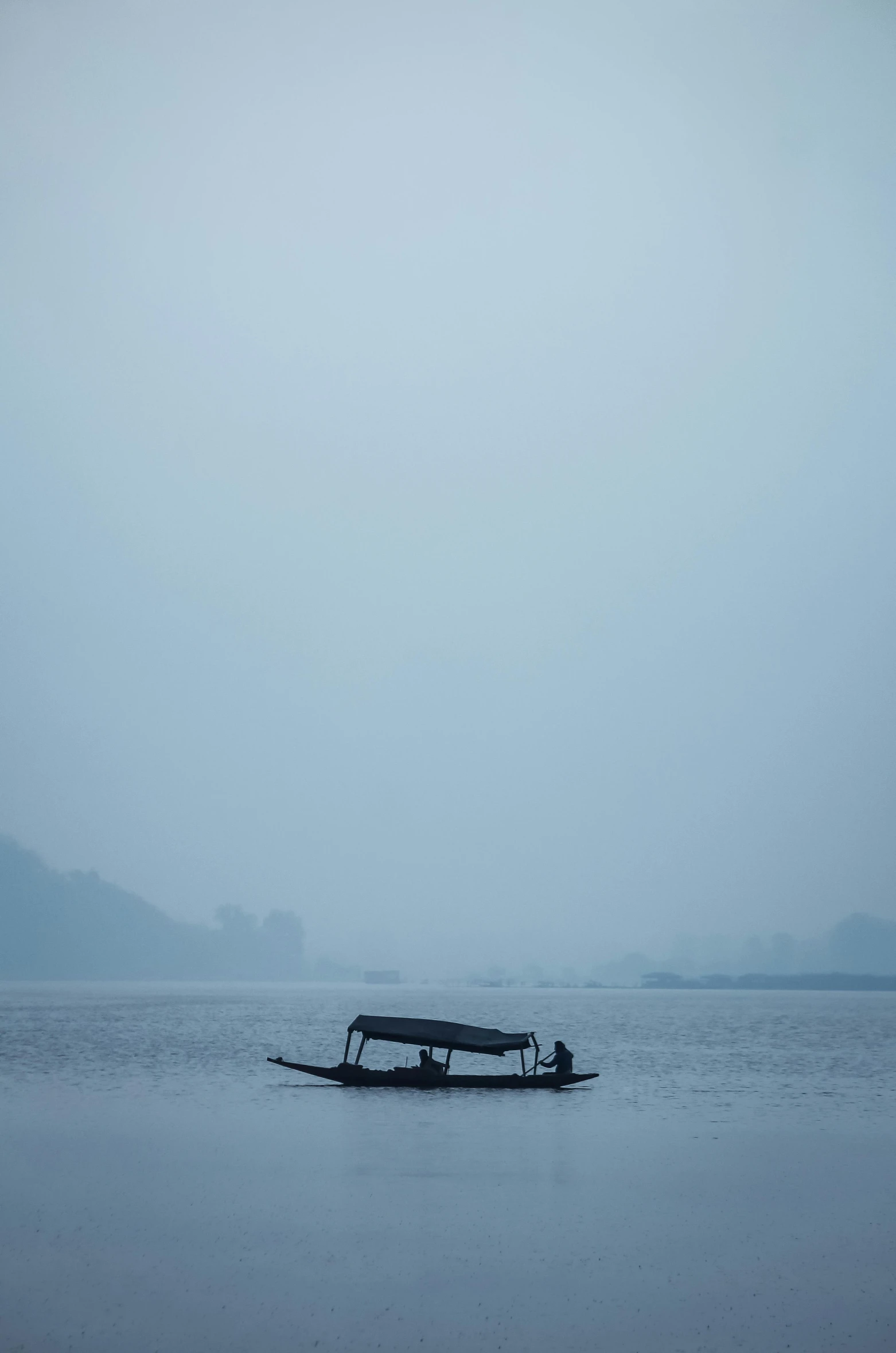 a small boat is in the middle of water