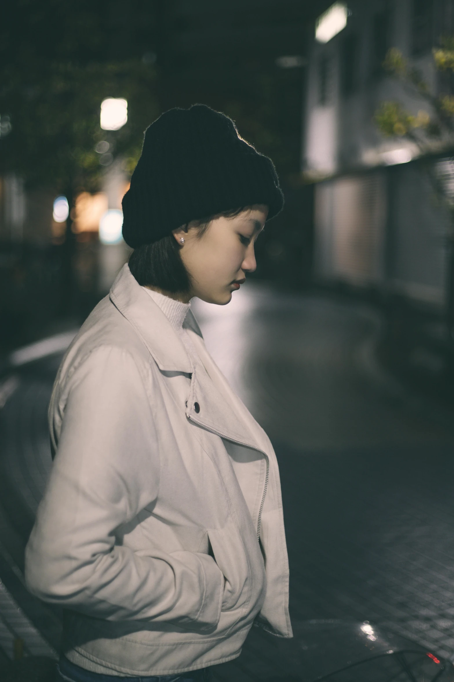 young woman on her cell phone at night